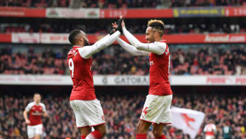 LONDON, ENGLAND - APRIL 01: Pierre-Emerick Aubameyang of Arsenal celebrates after scoring his sides second goal with Alexandre Lacazette of Arsenal during the Premier League match between Arsenal and Stoke City at Emirates Stadium on April 1, 2018 in London, England. (Photo by Shaun Botterill/Getty Images)