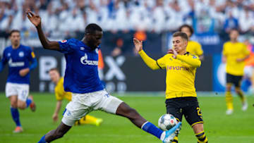 26 October 2019, North Rhine-Westphalia, Gelsenkirchen: Soccer: Bundesliga, FC Schalke 04 - Borussia Dortmund, 9th matchday in the Veltins Arena. Dortmund's Thorgan Hazard (r) and Schalkes Salif Sane fight for the ball. Photo: Guido Kirchner/dpa - IMPORTANT NOTE: In accordance with the requirements of the DFL Deutsche Fußball Liga or the DFB Deutscher Fußball-Bund, it is prohibited to use or have used photographs taken in the stadium and/or the match in the form of sequence images and/or video-like photo sequences. (Photo by Guido Kirchner/picture alliance via Getty Images)