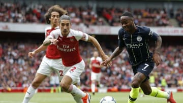 Manchester City's English midfielder Raheem Sterling (R) runs with the ball during the English Premier League football match between Arsenal and Manchester City at the Emirates Stadium in London on August 12, 2018. (Photo by Ian KINGTON / IKIMAGES / AFP) / RESTRICTED TO EDITORIAL USE. No use with unauthorized audio, video, data, fixture lists, club/league logos or 'live' services. Online in-match use limited to 45 images, no video emulation. No use in betting, games or single club/league/player publications. / (Photo credit should read IAN KINGTON/AFP/Getty Images)