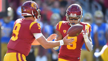 LOS ANGELES, CA - NOVEMBER 23: Quarterback Kedon Slovis #9 hands off the ball to wide receiver Amon-Ra St. Brown #8 of the USC Trojans in the first half of the game against the UCLA Bruins at the Los Angeles Memorial Coliseum on November 23, 2019 in Los Angeles, California. (Photo by Jayne Kamin-Oncea/Getty Images)