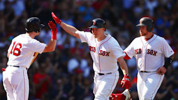 BOSTON, MA - September 16: Brock Holt #12 high fives Andrew Benintendi #16 of the Boston Red Sox after hitting a two-run home run in the third inning of a game against the New York Mets at Fenway Park on September 16, 2018 in Boston, Massachusetts. (Photo by Adam Glanzman/Getty Images)