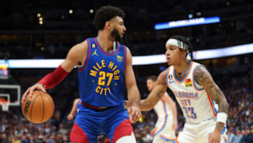 DENVER, CO - OCTOBER 22: Jamal Murray #27 of the Denver Nuggets is defended by Tre Mann #23 of the Oklahoma City Thunder in the fourth quarter at Ball Arena on October 22, 2022 in Denver, Colorado. NOTE TO USER: User expressly acknowledges and agrees that, by downloading and or using this Photograph, User is consenting to the terms and conditions of the Getty Images License Agreement. Mandatory Copyright Notice: Copyright 2022 NBAE (Photo by Justin Tafoya/Getty Images)
