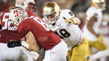 Nov 28, 2015; Stanford, CA, USA; Stanford Cardinal quarterback Kevin Hogan (8) is sacked by Notre Dame Fighting Irish linebacker Greer Martini (48) in the second quarter at Stanford Stadium. Mandatory Credit: Matt Cashore-USA TODAY Sports