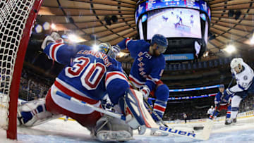 NEW YORK, NY - MAY 29: Henrik Lundqvist #30 of the New York Rangers makes a save as teammate Marc Staal #18 looks on agains Cedric Paquette #13 of the Tampa Bay Lightning in the second period of Game Seven of the Eastern Conference Finals during the 2015 NHL Stanley Cup Playoffs at Madison Square Garden on May 29, 2015 in New York City. (Photo by Elsa/Getty Images)
