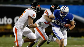 LAS VEGAS - DECEMBER 22: Andrew George #88 of the Brigham Young University Cougars runs for yardage against Sean Canfield #5 and Keith Pankey #35 of the Oregon State Beavers during the MAACO Las Vegas Bowl at Sam Boyd Stadium December 22, 2009 in Las Vegas, Nevada. (Photo by Ethan Miller/Getty Images)