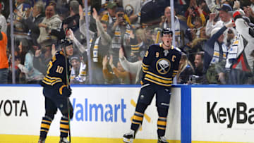 BUFFALO, NY - NOVEMBER 16: Henri Jokiharju #10 of the Buffalo Sabres looks on as Jack Eichel #9 celebrates his third goal of the game to give Buffalo a 3-2 lead during the third period of play against the Ottawa Senators at KeyBank Center on November 16, 2019 in Buffalo, New York. (Photo by Nicholas T. LoVerde/Getty Images)