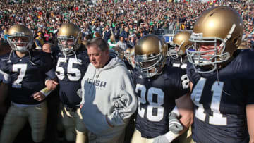SOUTH BEND, IN - NOVEMBER 21: Head coach Charlie Weis of the Notre Dame Fighting Irish waits to enter the field with (L-R) Jimmy Clausen #7, Eric Olsen #55, Kyle McCarthy #28 and Scott Smith #41 before a game against the University of Connecticut Huskies at Notre Dame Stadium on November 21, 2009 in South Bend, Indiana. (Photo by Jonathan Daniel/Getty Images)