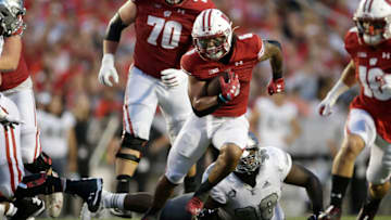 MADISON, WISCONSIN - SEPTEMBER 11: Chez Mellusi #6 of the Wisconsin Badgers rushes the ball in the third quarter against the Eastern Michigan Eagles at Camp Randall Stadium on September 11, 2021 in Madison, Wisconsin. (Photo by John Fisher/Getty Images)