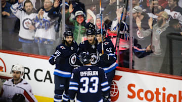 WINNIPEG, MB - FEBRUARY 13: Winnipeg Jets forward Bryan Little (18) is congratulated by his team mates Winnipeg Jets forward Matthieu Perreault (85) and Winnipeg Jets forward Jack Roslovic (52) during the NHL game between the Winnipeg Jets and the Washington Capitals on February 13, 2018 at the Bell MTS Place in Winnipeg, MB. (Photo by Terrence Lee/Icon Sportswire via Getty Images)