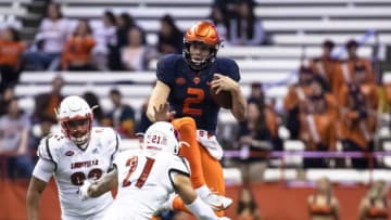 SYRACUSE, NY - NOVEMBER 09: Eric Dungey #2 of the Syracuse Orange attempts to hurdle London Iakopo #21 of the Louisville Cardinals during the second half at the Carrier Dome on November 9, 2018 in Syracuse, New York. (Photo by Brett Carlsen/Getty Images)