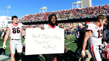ATLANTA, GA - NOVEMBER 27: Jackson Meeks #17 of the Georgia Bulldogs holds a sign after defeating the Georgia Tech Yellow Jackets 45-0 at Bobby Dodd Stadium on November 27, 2021 in Atlanta, Georgia. (Photo by Adam Hagy/Getty Images)