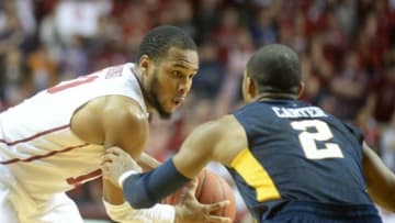 Jan 16, 2016; Norman, OK, USA; Oklahoma Sooners guard Jordan Woodard (10) handles the ball in front of West Virginia Mountaineers guard Jevon Carter (2) during the second half at Lloyd Noble Center. Mandatory Credit: Mark D. Smith-USA TODAY Sports