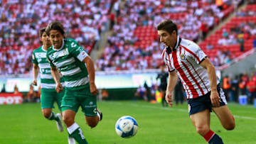 ZAPOPAN, MEXICO - AUGUST 12: Jose Abella (L) of Santos and Isaac Brizuela (R) of Chivas compete for the ball during the fourth round match between Chivas and Santos Laguna as part of the Torneo Apertura 2018 Liga MX at Akron Stadium on August 12, 2018 in Zapopan, Mexico. (Photo by Juan Mejia/Jam Media/Getty Images)