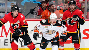 CALGARY, AB - FEBRUARY 22: Rickard Rakell #67 of the Anaheim Ducks and Sean Monahan #23 and Elias Lindholm #28 of the Calgary Flames skate during an NHL game on February 22, 2019 at the Scotiabank Saddledome in Calgary, Alberta, Canada. (Photo by Gerry Thomas/NHLI via Getty Images)