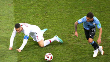 SOCHI, RUSSIA - JUNE 30: Cristiano Ronaldo of Portugal is challenged by Lucas Torreira of Uruguay during the 2018 FIFA World Cup Russia Round of 16 match between Uruguay and Portugal at Fisht Stadium on June 30, 2018 in Sochi, Russia. (Photo by Alex Livesey/Getty Images)