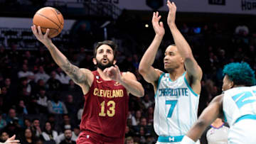 Mar 14, 2023; Charlotte, North Carolina, USA; Cleveland Cavaliers guard Ricky Rubio (13) drives past Charlotte Hornets guard Bryce McGowens (7) during the first half at the Spectrum Center. Mandatory Credit: Sam Sharpe-USA TODAY Sports