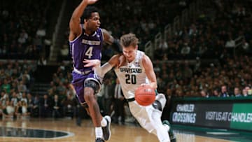 EAST LANSING, MI - JANUARY 02: Matt McQuaid #20 of the Michigan State Spartans drives to the basket while defended by Vic Law #4 of the Northwestern Wildcats in the first half at Breslin Center on January 2, 2019 in East Lansing, Michigan. (Photo by Rey Del Rio/Getty Images)