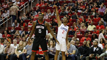 HOUSTON, TX - OCTOBER 26: Shai Gilgeous-Alexander #2 of the Los Angeles Clippers reacts after shooting a three point shot defended by Clint Capela #15 of the Houston Rockets in the second half at Toyota Center on October 26, 2018 in Houston, Texas. NOTE TO USER: User expressly acknowledges and agrees that, by downloading and or using this Photograph, user is consenting to the terms and conditions of the Getty Images License Agreement. (Photo by Tim Warner/Getty Images)