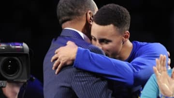 Dec 2, 2015; Charlotte, NC, USA; Charlotte Hornets former shooting guard Dell Curry (left) gets a hug from his son Stephen Curry (right) after being presented the key to Buzz City during a halftime ceremony at the game against the Golden State Warriors at Time Warner Cable Arena. Mandatory Credit: Sam Sharpe-USA TODAY Sports