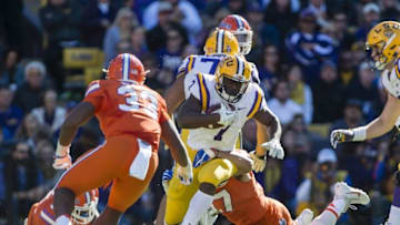Nov 19, 2016; Baton Rouge, LA, USA; LSU Tigers running back Leonard Fournette (7) is tackled by Florida Gators defensive lineman Caleb Brantley (57) during the first half at Tiger Stadium. Mandatory Credit: Jerome Miron-USA TODAY Sports
