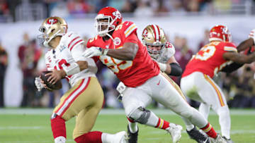 MIAMI, FLORIDA - FEBRUARY 02: Jimmy Garoppolo #10 of the San Francisco 49ers breaks a tackle from Chris Jones #95 of the Kansas City Chiefs during the second quarter in Super Bowl LIV at Hard Rock Stadium on February 02, 2020 in Miami, Florida. (Photo by Maddie Meyer/Getty Images)