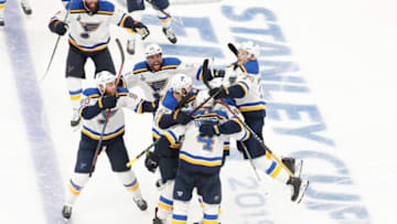 BOSTON, MA - MAY 29: Teammates mob St. Louis Blues defenseman Carl Gunnarsson (4) after his overtime winner during Game 2 of the 2019 Stanley Cup Finals between the Boston Bruins and the St. Louis Blues on May 29, 2019, at TD Garden in Boston, Massachusetts. (Photo by Fred Kfoury III/Icon Sportswire via Getty Images)