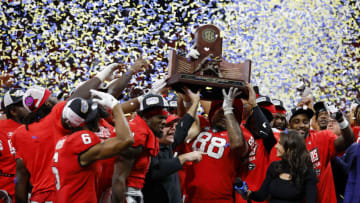 ATLANTA, GEORGIA - DECEMBER 03: The Georgia Bulldogs celebrate with the trophy after defeating the LSU Tigers in the SEC Championship game at Mercedes-Benz Stadium on December 03, 2022 in Atlanta, Georgia. (Photo by Todd Kirkland/Getty Images)