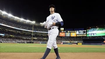 Sep 24, 2013; Bronx, NY, USA; New York Yankees third baseman Alex Rodriguez walks back to the dugout after flying out to end the fourth inning against the Tampa Bay Rays at Yankee Stadium. Mandatory Credit: John Munson/THE STAR-LEDGER via USA TODAY Sports