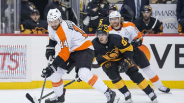PITTSBURGH, PA - MARCH 17: Philadelphia Flyers Center Sean Couturier (14) skates with the puck ahead of Pittsburgh Penguins Center Sidney Crosby (87) during the first period in the NHL game between the Pittsburgh Penguins and the Philadelphia Flyers on March 17, 2019, at PPG Paints Arena in Pittsburgh, PA. (Photo by Jeanine Leech/Icon Sportswire via Getty Images)