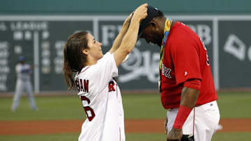 Aug 26, 2016; Boston, MA, USA; Olympic medalist Aly Raisman lets Boston Red Sox designated hitter David Ortiz (34) hold her Olympic medals as she get ready to throw out the first pitch against the Kansas City Royals at Fenway Park. Mandatory Credit: David Butler II-USA TODAY Sports