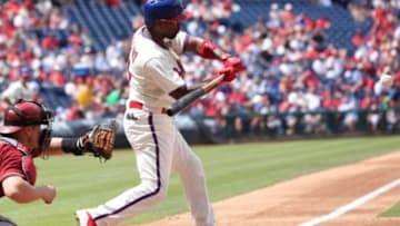 Jul 27, 2014; Philadelphia, PA, USA; Philadelphia Phillies shortstop Jimmy Rollins (11) singles to right during the third inning against the Arizona Diamondbacks at Citizens Bank Park. The Phillies won 4-2. Mandatory Credit: Bill Streicher-USA TODAY Sports