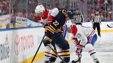 BUFFALO, NY - NOVEMBER 23: Johan Larsson #22 of the Buffalo Sabres battles for the puck against Jesperi Kotkaniemi #15 and Max Domi #13 of the Montreal Canadiens during an NHL game on November 23, 2018 at KeyBank Center in Buffalo, New York. (Photo by Bill Wippert/NHLI via Getty Images)