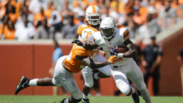 KNOXVILLE, TN - SEPTEMBER 15: Running back Quardraiz Wadley #4 of the UTEP Miners runs for yards with Linebacker Daniel Bituli #35 of the Tennessee Volunteers in pursuit during the second half of the game between the UTEP Miners and Tennessee Volunteers at Neyland Stadium on September 15, 2018 in Knoxville, Tennessee. Tennessee won the game 24-0. (Photo by Donald Page/Getty Images)