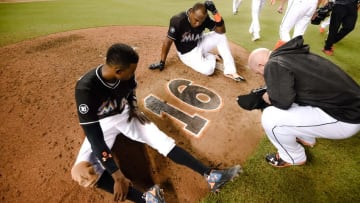Sep 28, 2016; Miami, FL, USA; Miami Marlins second baseman Dee Gordon (left) center fielder Marcell Ozuna (top) and relief pitcher Mike Dunn (right) take a moment in honor of deceased Marlins starting pitcher Jose Fernandez at the pitchers mound after their game against the New York Mets at Marlins Park. The Mets won 5-2. Mandatory Credit: Steve Mitchell-USA TODAY Sports