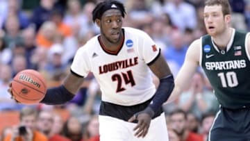 Mar 29, 2015; Syracuse, NY, USA; Louisville Cardinals forward Montrezl Harrell (24) handles the ball against Michigan State Spartans forward Matt Costello (10) during the second half in the finals of the east regional of the 2015 NCAA Tournament at Carrier Dome. Mandatory Credit: Mark Konezny-USA TODAY Sports