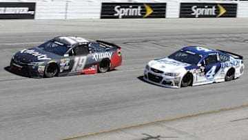 Apr 24, 2016; Richmond, VA, USA; Sprint Cup Series driver Carl Edwards (19) races driver Kevin Harvick (4) during the Toyota Owners 400 at Richmond International Raceway. Mandatory Credit: Amber Searls-USA TODAY Sports