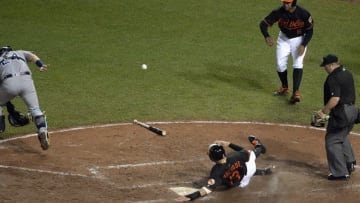 Jun 24, 2016; Baltimore, MD, USA; Baltimore Orioles third baseman Manny Machado (13) scores on first baseman Chris Davis (19) (not pictured) three single during the sixth inning against the Tampa Bay Rays at Oriole Park at Camden Yards. Baltimore Orioles defeated Tampa Bay Rays 6-3. Mandatory Credit: Tommy Gilligan-USA TODAY Sports