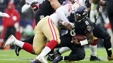BALTIMORE, MARYLAND - DECEMBER 01: Lamar Jackson #8 of the Baltimore Ravens is tackled as he runs with the ball during the first half against the San Francisco 49ers at M&T Bank Stadium on December 01, 2019 in Baltimore, Maryland. (Photo by Patrick Smith/Getty Images)
