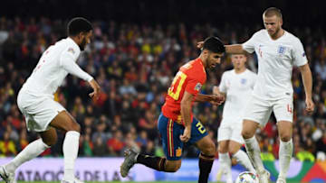 SEVILLE, SPAIN - OCTOBER 15: Marco Asensio of Spain takes on Joe Gomez and Eric Dier of England during the UEFA Nations League A Group Four match between Spain and England at Estadio Benito Villamarin on October 15, 2018 in Seville, Spain. (Photo by David Ramos/Getty Images)