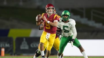 Dec 18, 2020; Los Angeles, California, USA; Southern California Trojans quarterback Kedon Slovis (9) is pressured by Oregon Ducks defensive end Kayvon Thibodeaux (5) in the second half during the Pac-12 Championship at United Airlines Field at Los Angeles Memorial Coliseum. Oregon defeated USC 31-24. Mandatory Credit: Kirby Lee-USA TODAY Sports