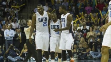 Mar 31, 2014; Charlotte, NC, USA; Charlotte Bobcats center Al Jefferson (25), guard Kemba Walker (15), and forward Michael Kidd-Gilchrist (14) reacts after a turnover during the second half against the Washington Wizards at Time Warner Cable Arena. Bobcats defeated the Wizards 100-94. Mandatory Credit: Jeremy Brevard-USA TODAY Sports