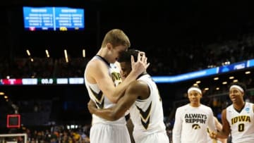 Mar 18, 2016; Brooklyn, NY, USA; Iowa Hawkeyes center Adam Woodbury (left) hugs guard Anthony Clemmons (5) after making the game-winning basket against the Temple Owls in overtime in the first round of the 2016 NCAA Tournament at Barclays Center. Mandatory Credit: Anthony Gruppuso-USA TODAY Sports