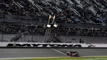 Feb 13, 2016; Daytona Beach, FL, USA; NASCAR Sprint Cup Series driver Denny Hamlin (11) crosses the finish line to win The Sprint Unlimited at Daytona International Speedway. Mandatory Credit: Jasen Vinlove-USA TODAY Sports