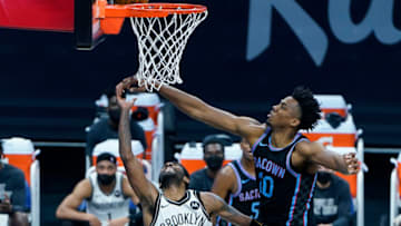 SACRAMENTO, CALIFORNIA - FEBRUARY 15: Hassan Whiteside #20 of the Sacramento Kings goes up to block the shot of Kyrie Irving #11 of the Brooklyn Nets during the first half of an NBA basketball game at Golden 1 Center on February 15, 2021 in Sacramento, California. NOTE TO USER: User expressly acknowledges and agrees that, by downloading and or using this photograph, User is consenting to the terms and conditions of the Getty Images License Agreement. (Photo by Thearon W. Henderson/Getty Images)