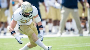ATLANTA, GA - SEPTEMBER 1: Linebacker David Curry #32 of the Georgia Tech Yellow Jackets picks up a fumble during their game against the Alcorn State Braves at Bobby Dodd Stadium on September 1, 2018 in Atlanta, Georgia. (Photo by Michael Chang/Getty Images)