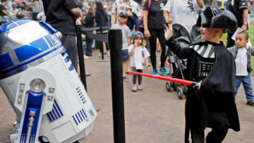 CHICAGO, IL - AUGUST 26: A young fan dressed as Darth Vader waves to R2-D2 before the game between the Chicago White Sox and the Detroit Tigers at Guaranteed Rate Field on August 26, 2017 in Chicago, Illinois. (Photo by Jon Durr/Getty Images)