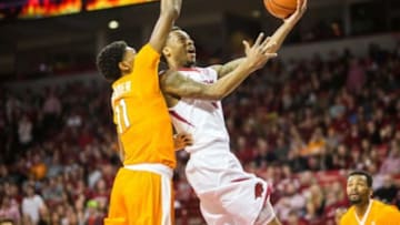 Feb 6, 2016; Fayetteville, AR, USA; Arkansas Razorbacks guard Anthlon Bell (R) shoots the ball past Tennessee Volunteers forward Kyle Alexander (11) during the first half at Bud Walton Arena. Mandatory Credit: Gunnar Rathbun-USA TODAY Sports