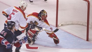 John Vanbiesbrouck of the Florida Panthers tries to make a save against the New York Rangers