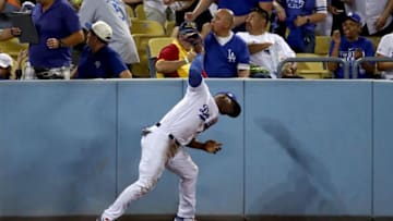 LOS ANGELES, CA - OCTOBER 25: Yasiel Puig #66 of the Los Angeles Dodgers throws his glove after he was unable to catch a ground rule double hit by Alex Bregman #2 of the Houston Astros (not pictured) during the eighth inning in game two of the 2017 World Series at Dodger Stadium on October 25, 2017 in Los Angeles, California. (Photo by Ezra Shaw/Getty Images)