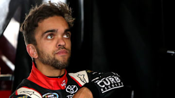LONG POND, PA - JULY 29: Rico Abreu, driver of the #98 Safelite Auto Glass/Curb Records Toyota, stands in the garage area during practice for the NASCAR Camping World Truck Series Pocono Mountains 150 at Pocono Raceway on July 29, 2016 in Long Pond, Pennsylvania. (Photo by Sean Gardner/Getty Images)
